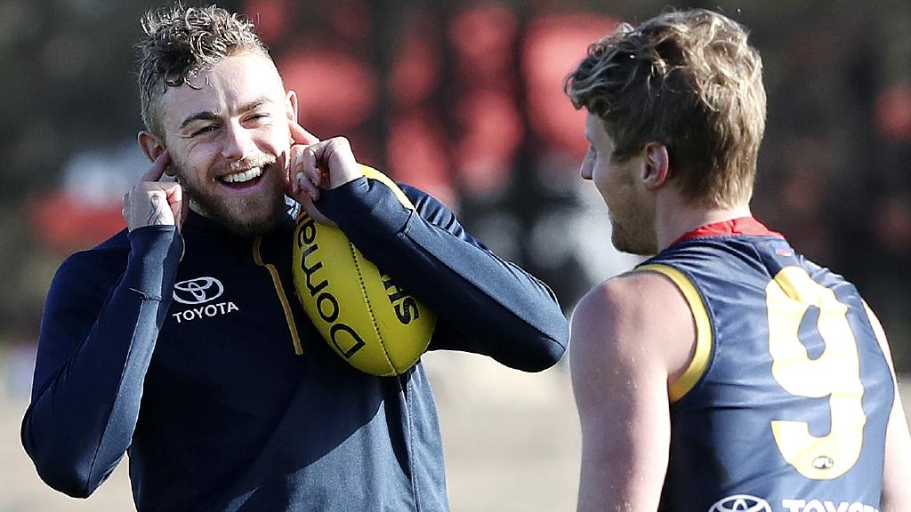 Hugh Greenwood blocks his ears while talking to Rory Sloane.