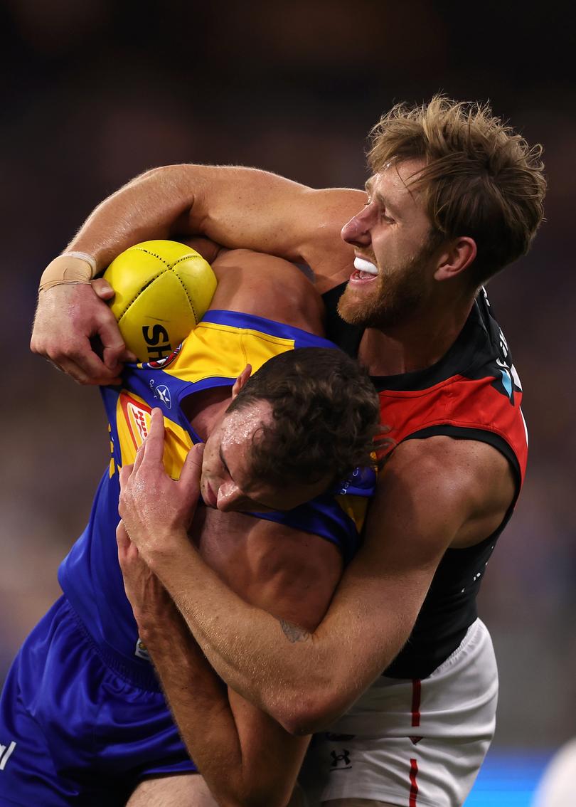 PERTH, AUSTRALIA - MAY 04: Dyson Heppell of the Bombers tackles Luke Edwards of the Eagles during the round eight AFL match between West Coast Eagles and Essendon Bombers at Optus Stadium, on May 04, 2024, in Perth, Australia. (Photo by Paul Kane/Getty Images)