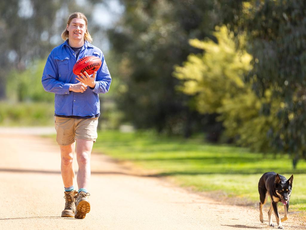 Harley Reid on his uncle’s farm in Kyabram with farm dog Macy. Picture: Mark Stewart