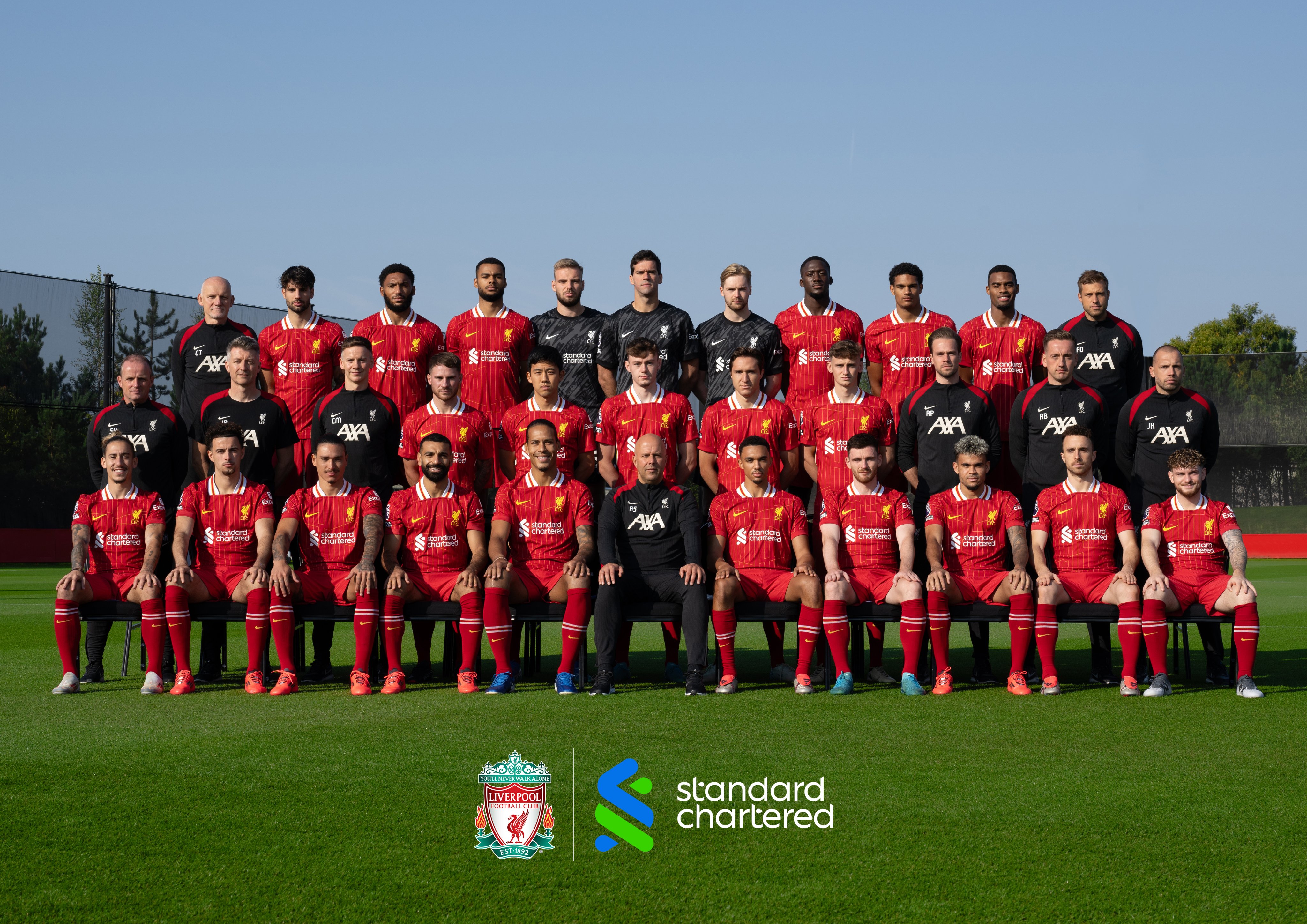 LFC team photo for the 24/25 season. Back Row:  Claudio Taffarel (Goalkeeping Coach), Dominik Szoboszlai, Joe Gomez, Cody Gakpo, Vitezslav Jaros, Alisson Becker, Caoimhin Kelleher, Ibrahima Konate, Jarell Quansah, Ryan Gravenberch, Fabian Otte (Head of First Team Goalkeeper Coaching).Middle Row:  Sipke Hulshoff (First Assistant Coach), Jonathan Power (Doctor), Conall Murtagh (Head of Physical Performance), Alexis Mac Allister, Wataru Endo, Conor Bradley, Federico Chiesa, Tyler Morton, Ruben Peeters (Lead Physical Performance Coach), Aaron Briggs (First Team Individual Development Coach), John Heitinga (Assistant Coach).Front Row:  Kostas Tsimikas, Curtis Jones, Darwin Nunez, Mohamed Salah, Virgil Van Dijk (Captain), Arne Slot (Head Coach) Trent Alexander-Arnold (Vice Captain), Andy Robertson, Luis Diaz, Diogo Jota, Harvey Elliott.