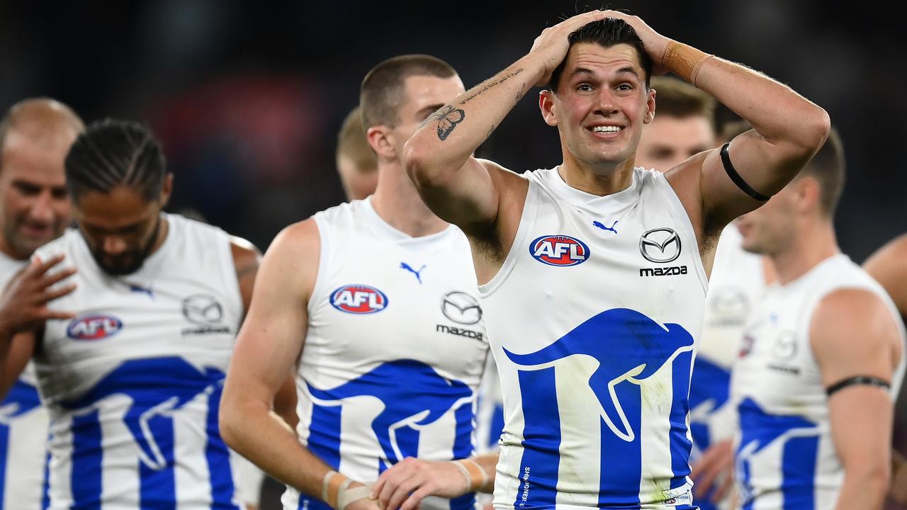 North Melbourne players trudge off after their heavy loss to Melbourne.