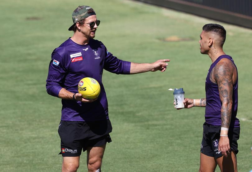 Nat Fyfe and [PLAYERCARD]Michael Walters[/PLAYERCARD] on the sideline.