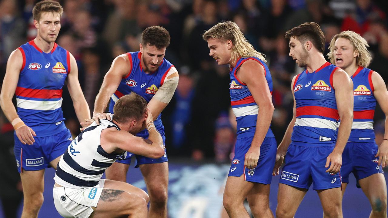 [PLAYERCARD]Zach Tuohy[/PLAYERCARD] grabs his head after the contact from the Bulldogs star. Picture: Michael Klein