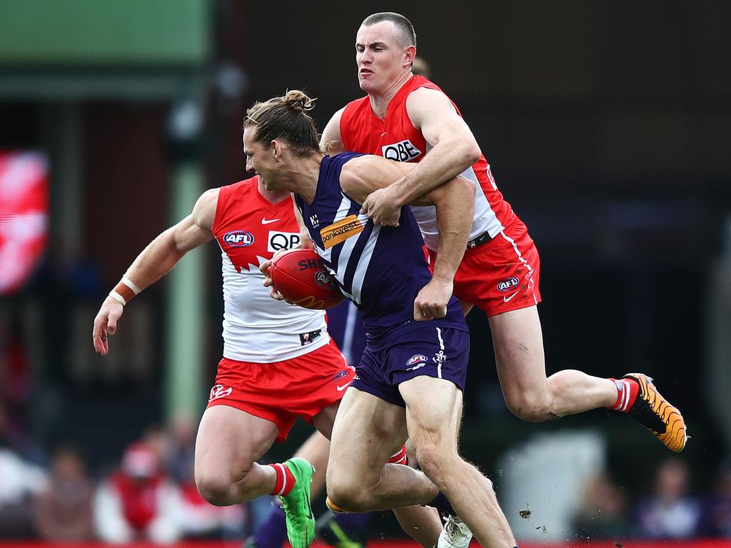 Chad Warner tackles Nat Fyfe during Fremantle’s win on Saturday. Picture: Brett Costello