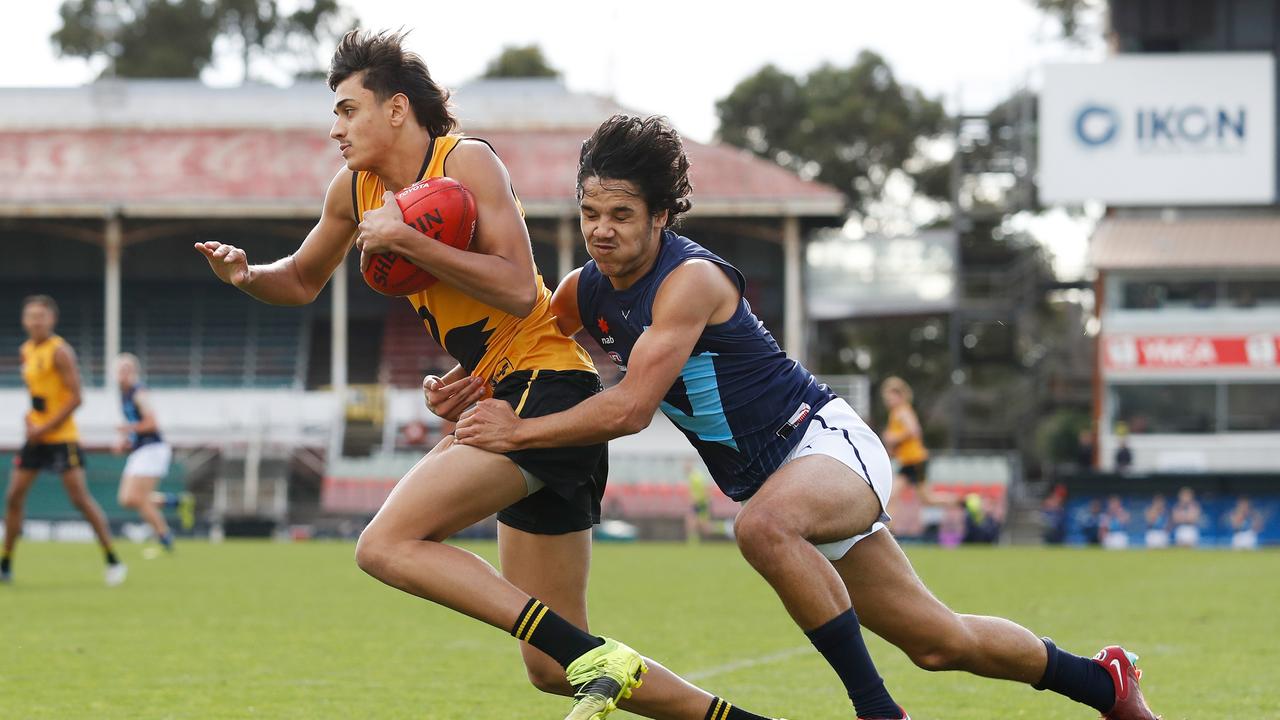 Jordyn Baker is tackled by [PLAYERCARD]Alwyn Davey[/PLAYERCARD] of Victoria Metro. Picture: Dylan Burns