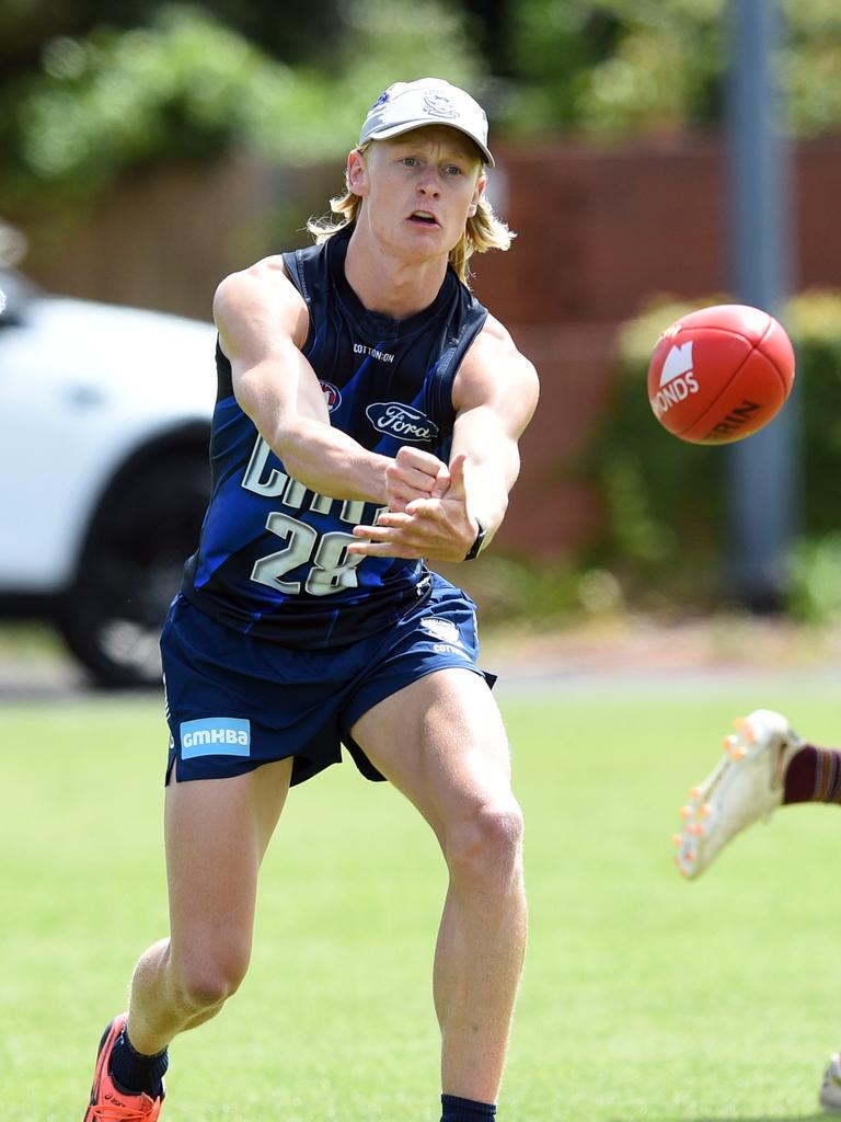 Ollie Dempsey fires a handball.