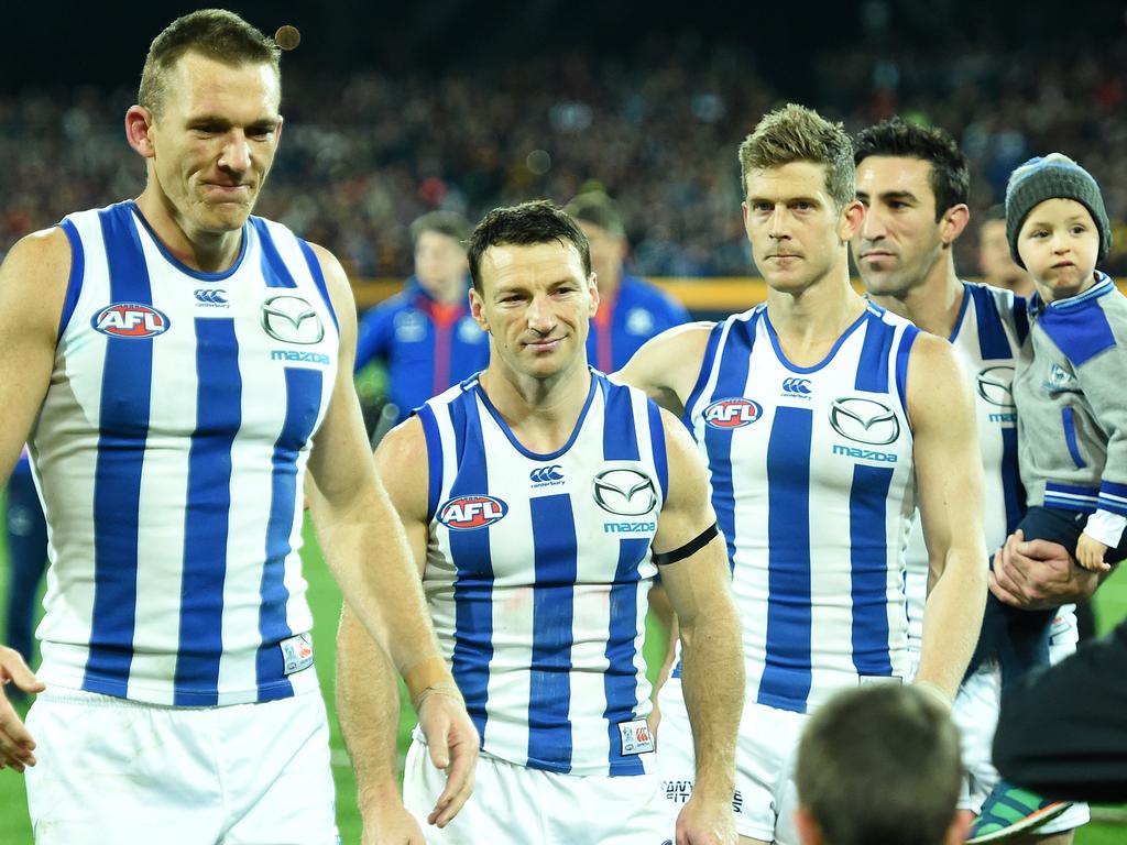 North Melbourne champions, Drew Petrie, [PLAYERCARD]Brent Harvey[/PLAYERCARD], [PLAYERCARD]Nick Dal Santo[/PLAYERCARD] and [PLAYERCARD]Michael Firrito[/PLAYERCARD] after their final game for the club in 2016. Picture: Tom Huntley
