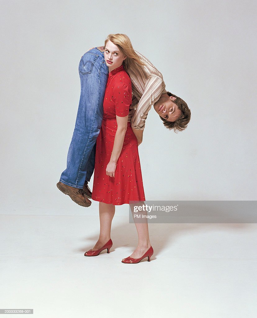 woman-carrying-man-on-shoulder-picture-id200333268-001