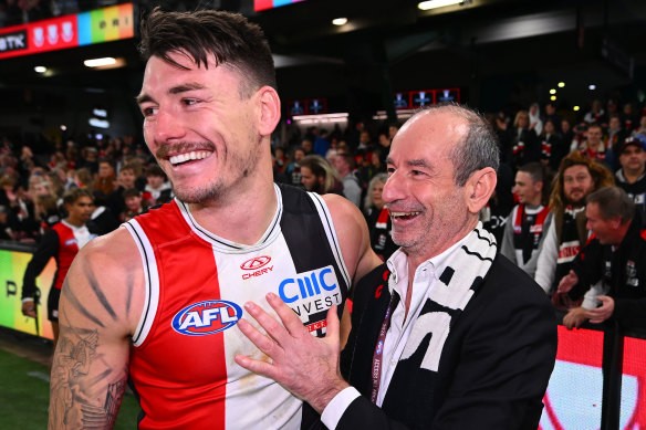 St Kilda president Andrew Bassat (right) embraces [PLAYERCARD]Josh Battle[/PLAYERCARD] following the Saints’ win over the Swans.