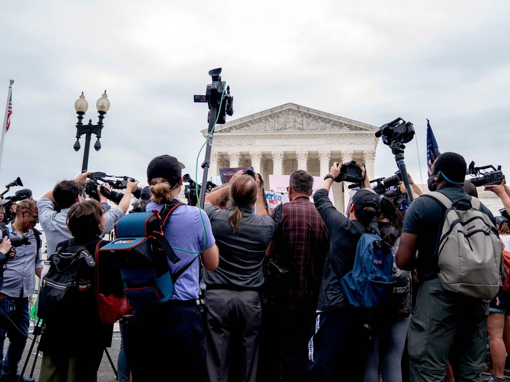 Members of the media gather around demonstrators outside the US Supreme Court. Picture: AFP