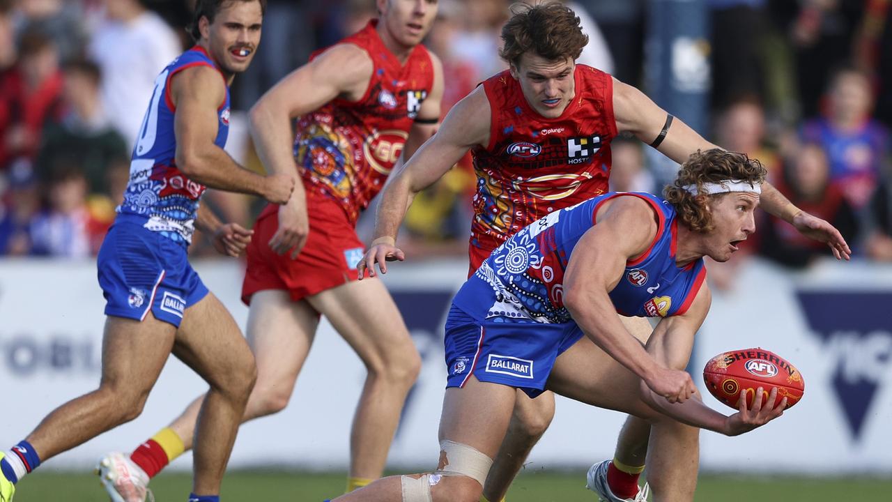 [PLAYERCARD]Aaron Naughton[/PLAYERCARD] handballs before being tackled at Mars Stadium in Ballarat. Picture: Martin Keep/Getty Images