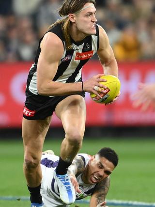 [PLAYERCARD]Darcy Moore[/PLAYERCARD] avoids a tackle from [PLAYERCARD]Michael Walters[/PLAYERCARD]. Picture: Getty Images