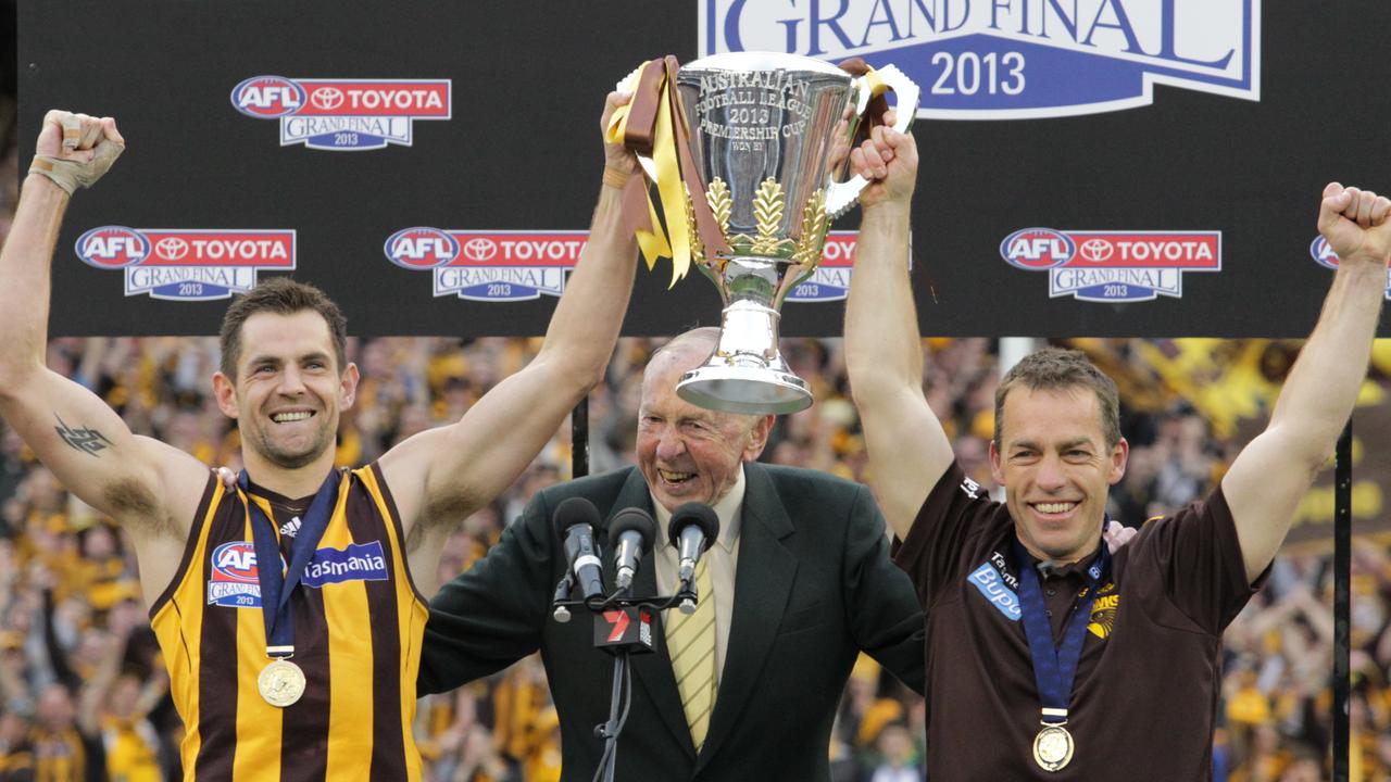 Alastair Clarkson and Luke Hodge lift the 2013 premiership cup. (AAP Image/David Crosling)