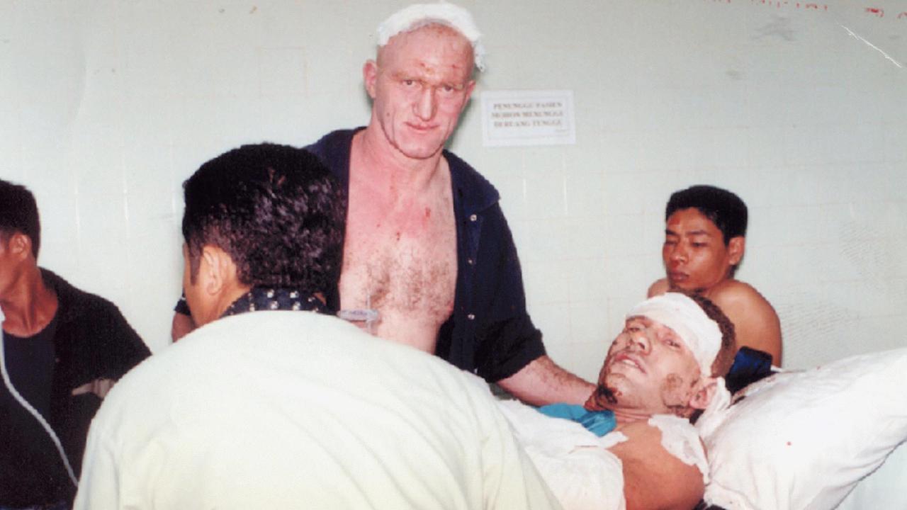 McCartney lays on stretcher comforted by his mate Mick Martyn just hours after the bomb blast. Picture: Bali Post.