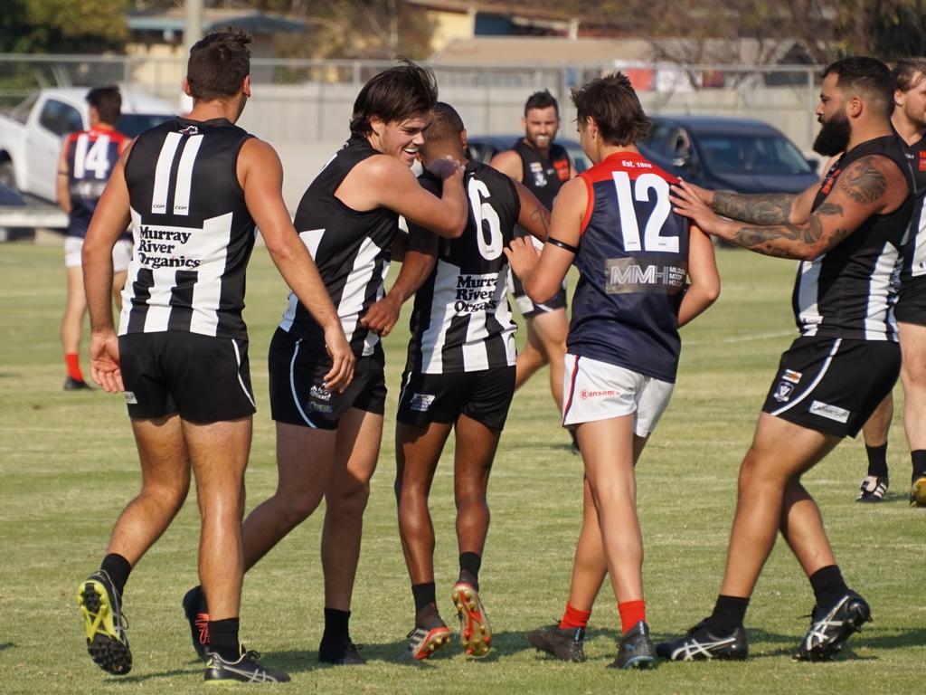 Josh Carmichael (second left) celebrates his teammate kicking a goal in a Merbein win over Mildura. Picture: Michael DiFabrizio/NCA