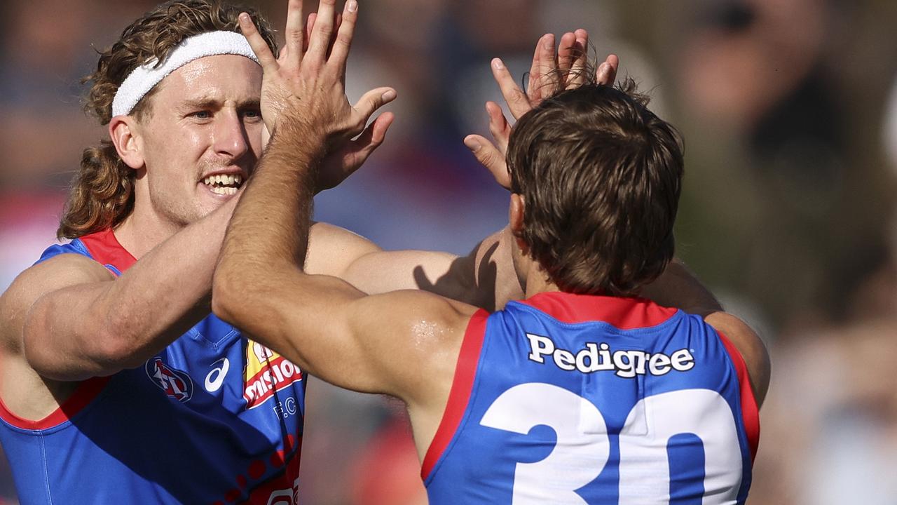 [PLAYERCARD]Aaron Naughton[/PLAYERCARD] (left) celebrates a goal against the Gold Coast Suns. Picture: Martin Keep/Getty Images