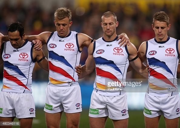 480346116-crows-players-line-up-for-a-moments-silence-gettyimages.jpg