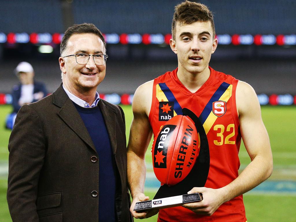 Valente is presented the award for best player during a match at the 2018 U18 AFL Championships. Picture: Michael Dodge/Getty Images