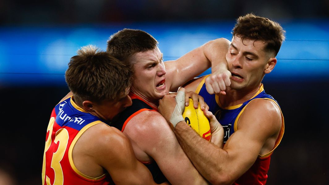 Zac-Bailey-and-Josh-Dunkley-tackle-Sam-Walsh-during-the-R8-match-between-Brisbane-and-Carlton-at-Marvel-Stadium-on-May-5-2023.jpg