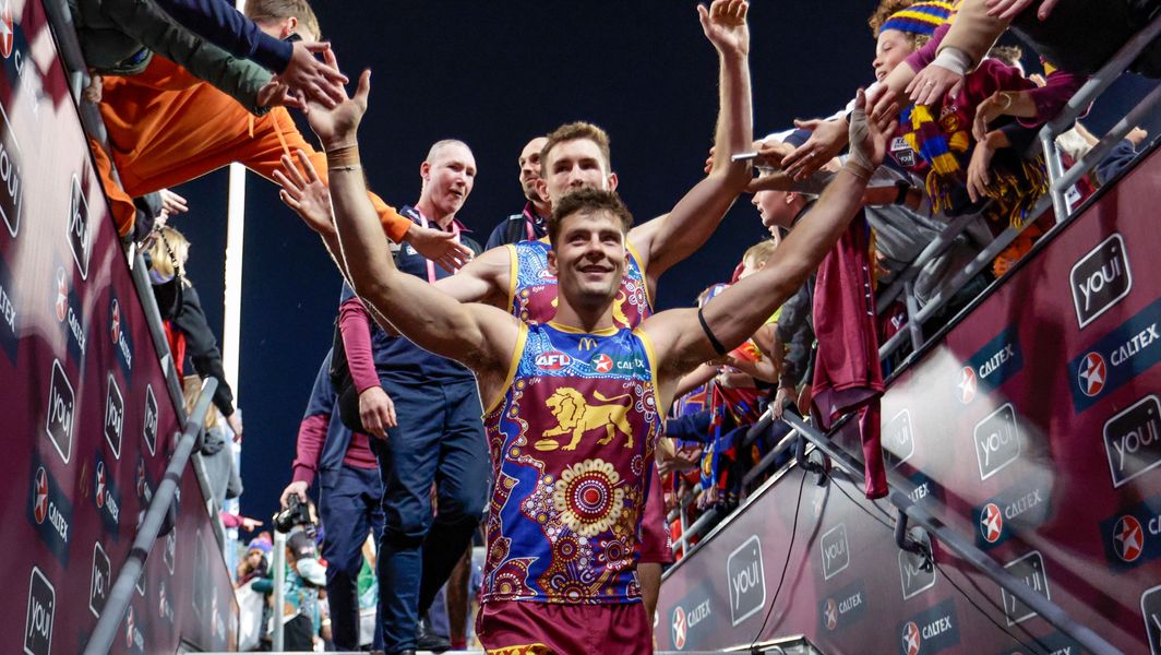 Josh-Dunkley-high-fives-fans-after-the-R10-match-between-Brisbane-and-Gold-Coast-at-the-Gabba-on-May-20-2023.jpg
