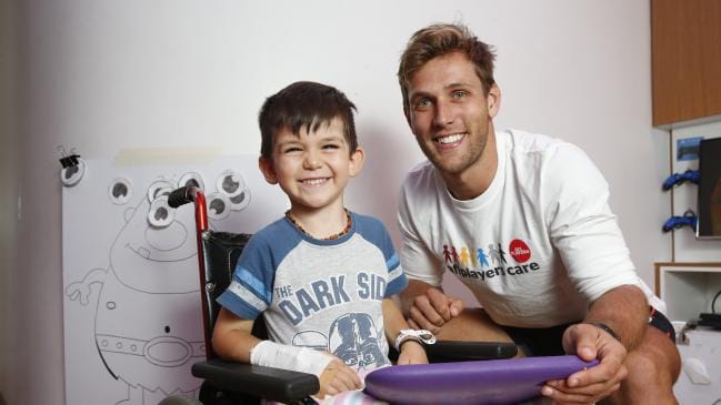 Giants player Matt de Boer visits patient Luke Nikolic, 4, in the Starlight Room at Westmead Children's Hospital. Picture: David Swift.