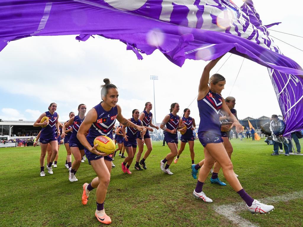 Freo’s Ange Stannett (L) runs through the banner ahead of the round one derby against West Coast Eagles at Fremantle Oval. Picture: Daniel Carson/AFL Photos via Getty Images