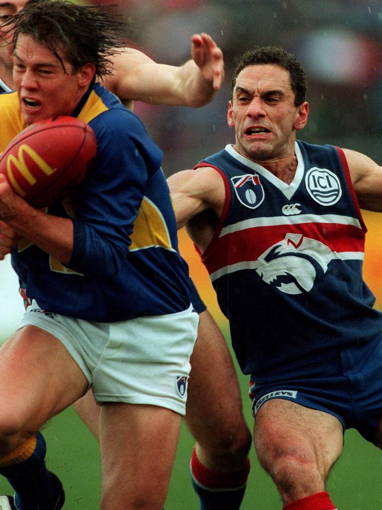 [PLAYERCARD]Tony Liberatore[/PLAYERCARD] attempts to tackle Eagle Ben Cousins in Round 21, 1997.