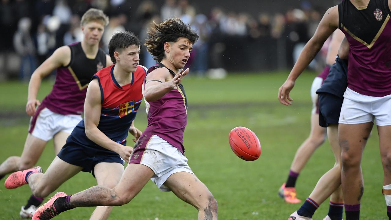 Charlie Rowe gets a kick away for Haileybury. Picture: Andrew Batsch