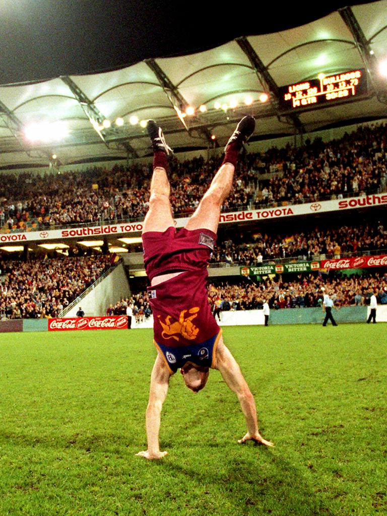 Jason Akermanis performs his famous handstand at the Gabba.