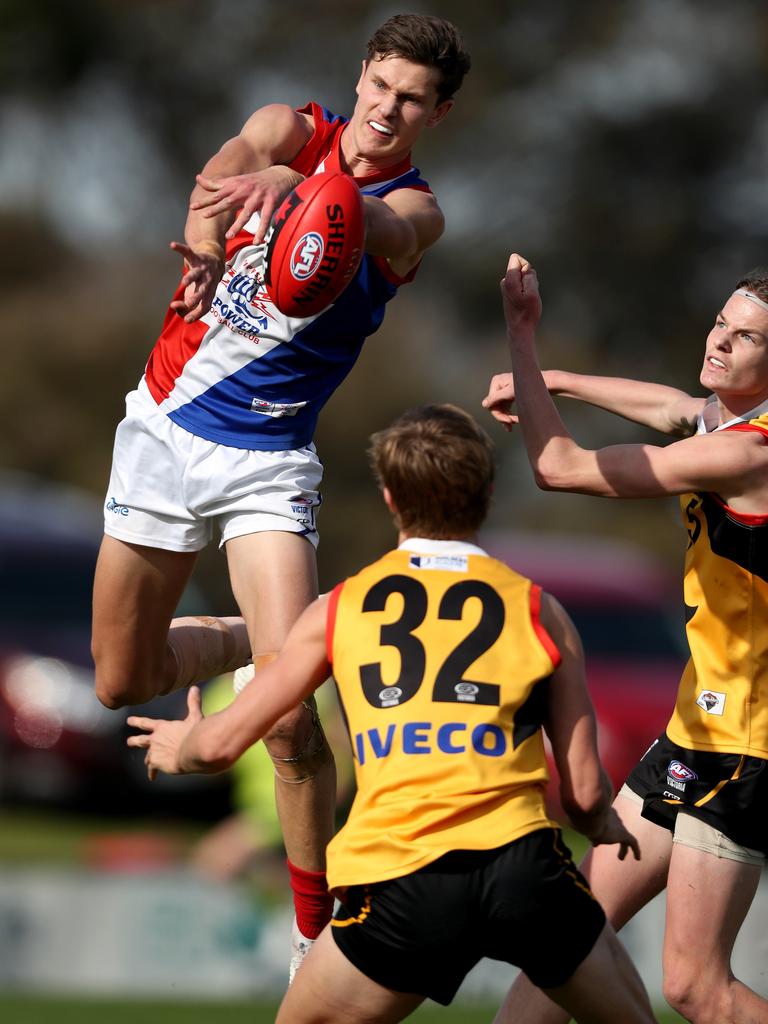 Charlie Comben flies for a mark playing for Gippsland Power.