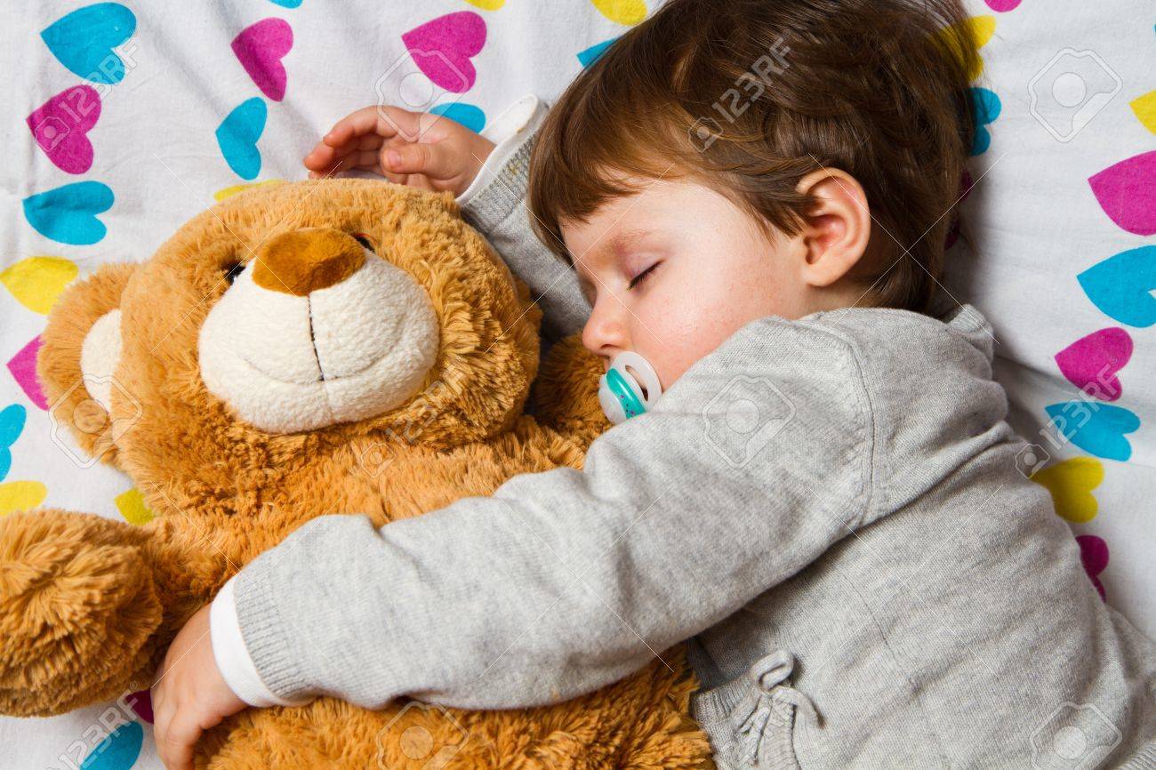 16524138-sweet-child-sleeping-with-teddy-bear.jpg