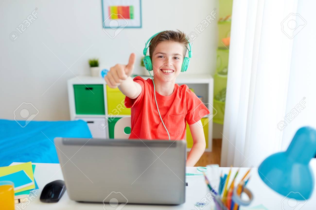 88065338-technology-gaming-and-people-concept-happy-smiling-boy-in-headphones-playing-video-game-on-laptop-co.jpg